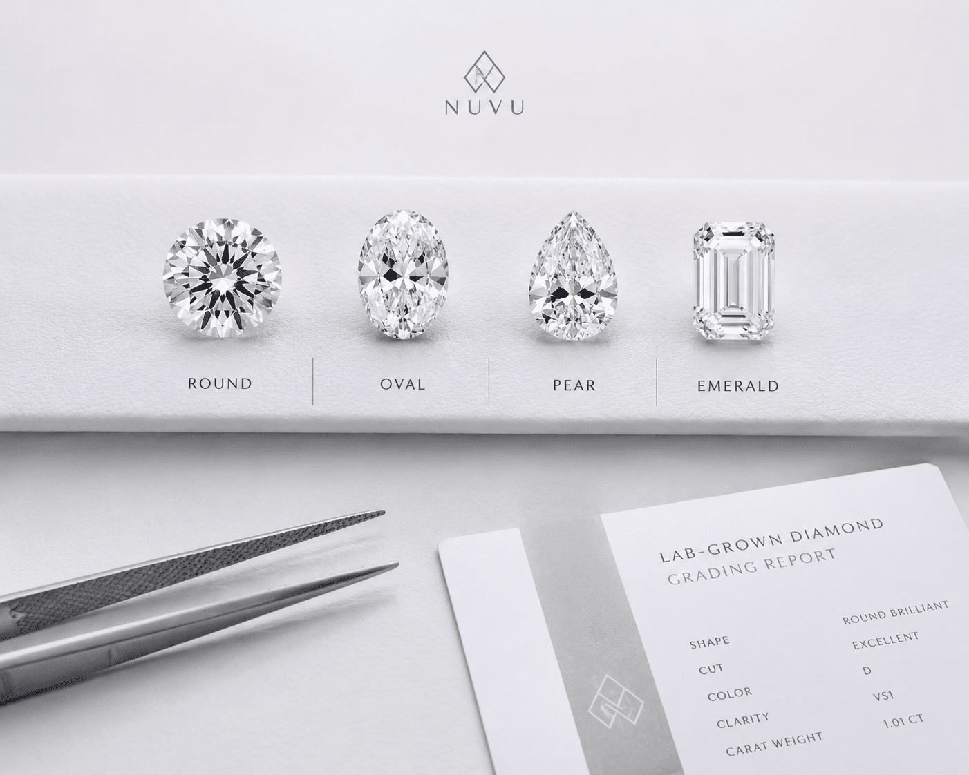 Side-by-side comparison of loose round, oval, pear, and emerald cut lab-grown diamonds on a white display background