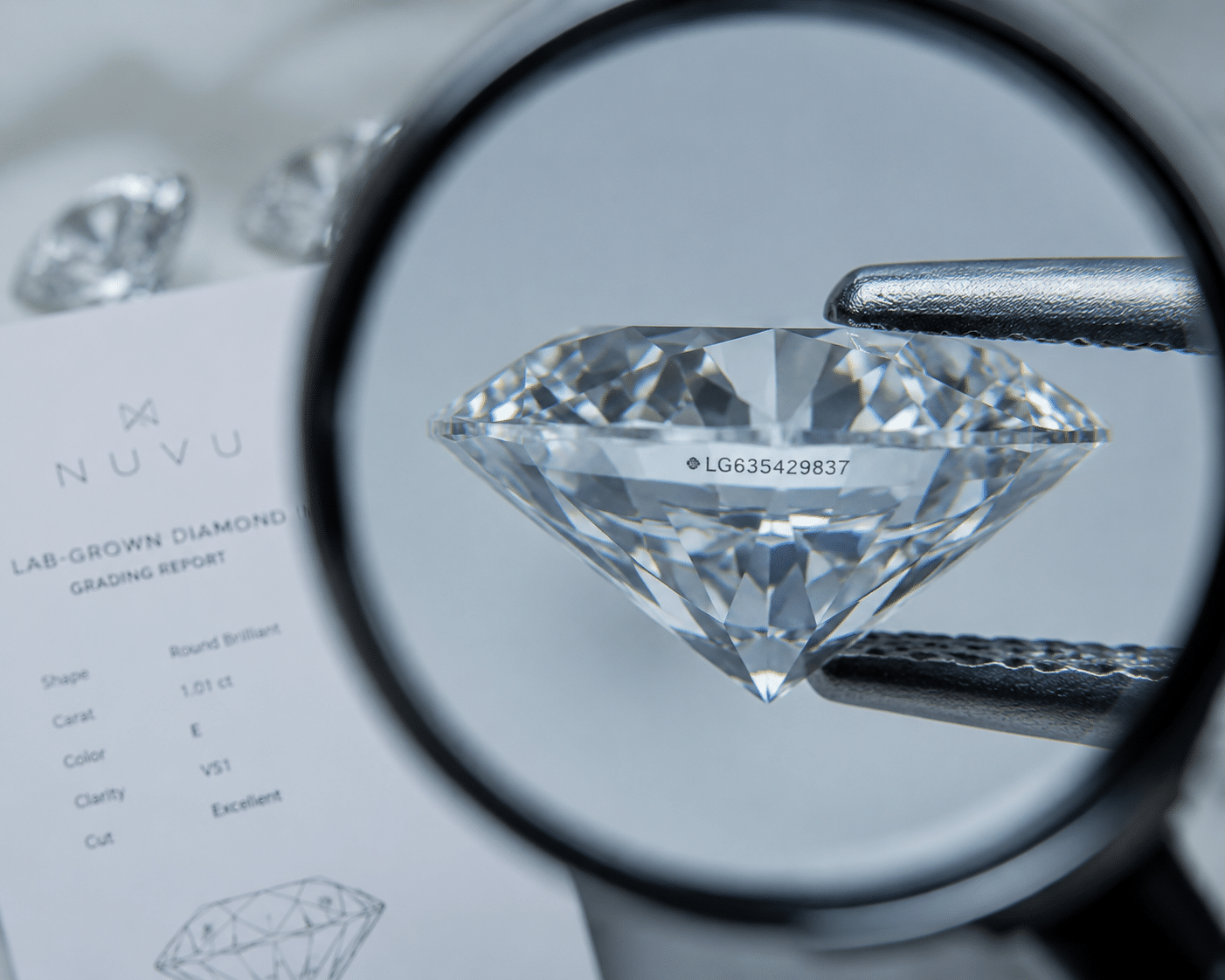 Close-up of a lab-grown diamond with a laser-inscribed report number visible along the girdle under magnification