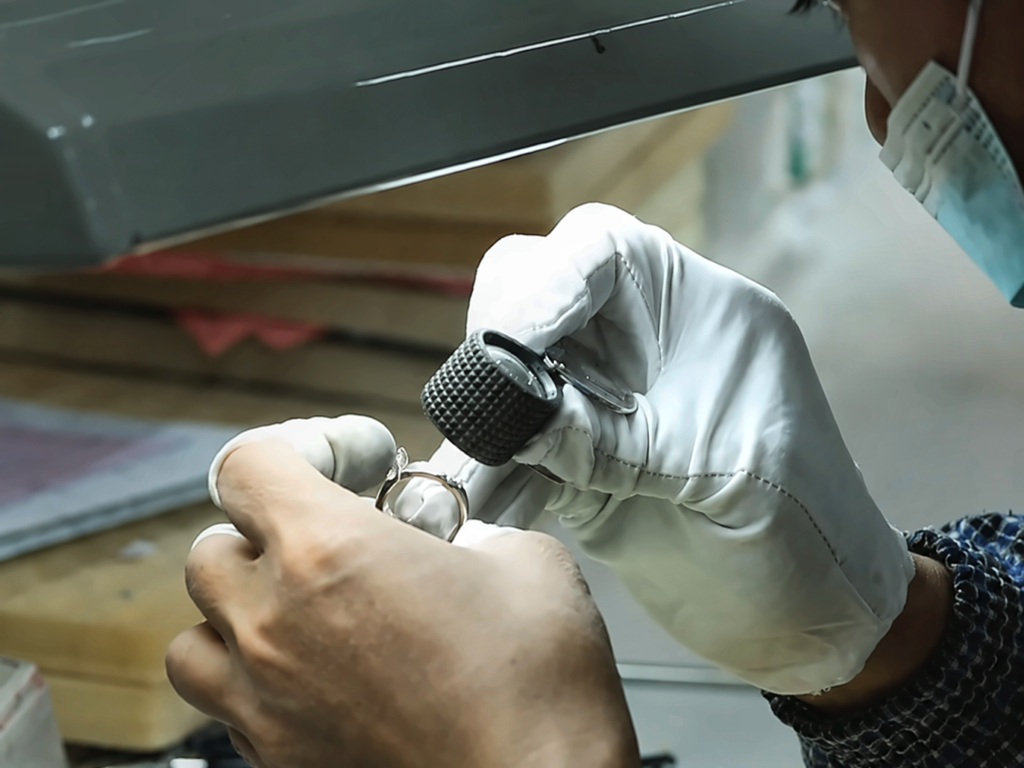 Finished diamond ring undergoing visual inspection under task lighting